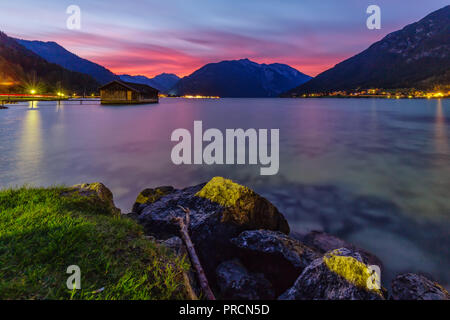 Long after sunset at Lake Achensee in Austria the sky colored wonderful red. Stock Photo