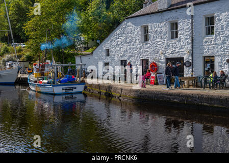 Cafe and fishing boat in the Crinan Canal Basin, Argyll Scotland Stock Photo