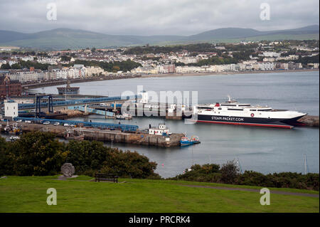 View from Douglas Head of Steam Packet catamaran at berth on Victoria pier and Ferry Terminal with Douglas Town in background on cloudy day. Stock Photo