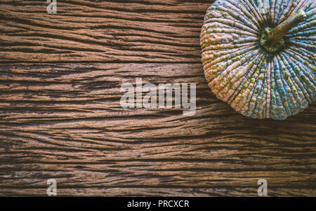 Top View of raw pumpkin on gruge wooden background. Fresh organic vegetable, top view with copy space. Stock Photo
