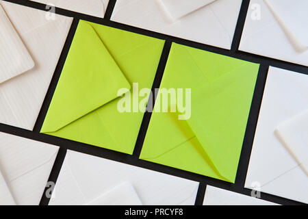 Composition with white and green envelopes on the table. Different colored envelopes on the table. Stock Photo