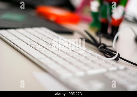 Modern grey keyboard with white keys. Selective focus Stock Photo