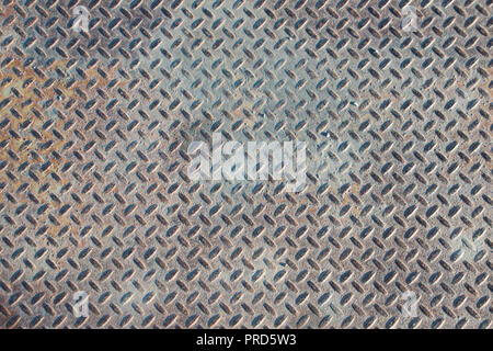 Closeup landscape of a distressed, mottled, gungy industrial diamondplate, chequerplate rusty metal background texture with diamond grip pattern Stock Photo