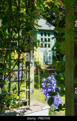 House Back garden with summerhouse and beautiful flower displays, arch,  bespoke summerhouse,  Central Scotland, UK Stock Photo