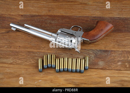 wild west revolver - colt single action army on wooden background Stock Photo