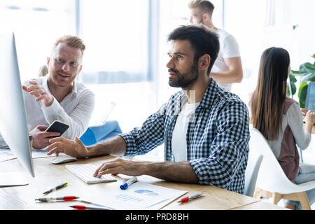 Coworking process, designers team working modern office Stock Photo