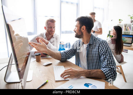 Coworking process, designers team working modern office Stock Photo