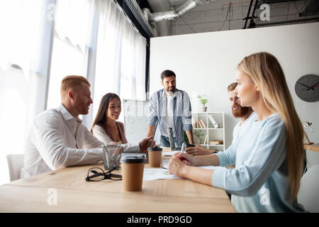 Young team of coworkers making great business discussion in modern coworking office.Teamwork people concept Stock Photo