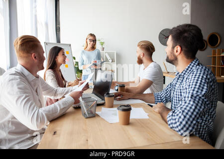 Young team of coworkers making great business discussion in modern coworking office.Teamwork people concept Stock Photo