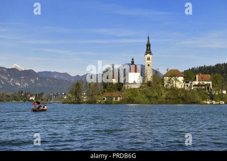 Island Blejski Otok with St. Mary's Church, Lake Bled with excursion boat, Bled, Slovenia Stock Photo