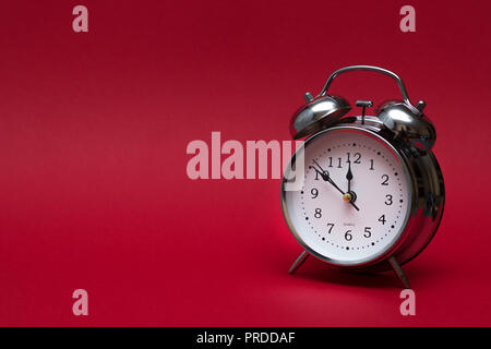 red alarm clock on red background. close up shot. top view. For time concept. Stock Photo