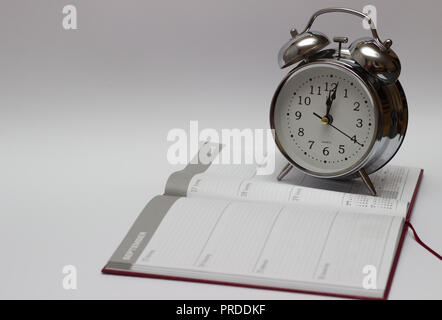 alarm clock and diary on a white background. Stock Photo