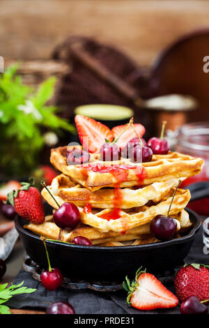 Belgian waffles with fresh berries and jam for breakfast Stock Photo