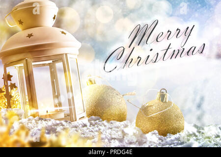 Christmas card with lantern on the snow with christmas balls in snowy landscape with sunbeams. Horizontal composition. Stock Photo