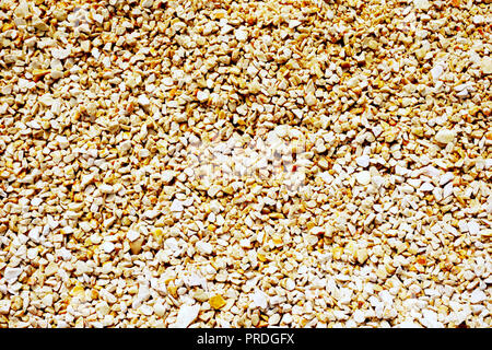 Pebble background. Small fine gravel in warm earth tone color. Big dimension background Stock Photo