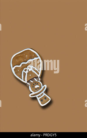 gingerbread man, snowman, head over, isolated on brown background, close up, flat lay, vertical Stock Photo
