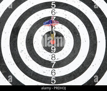 A dart with USA flag on the fletching in the center circle of a target Stock Photo