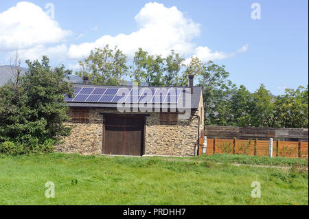 solar roof on a very small barn in a village in the Pyrenees Stock Photo