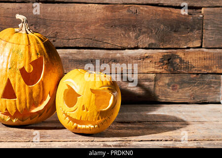 Two Halloween pumpkins on rustic wood background. Stock Photo