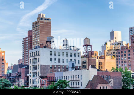 Water towers or rooftop Water Tank on an Apartment Building in New York. Deposits typical of a rooftop in the city of New York, USA. Stock Photo