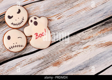 Halloween gingerbread cookies on wooden background. Stock Photo
