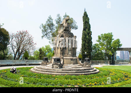 Garden and top of Chapultepec castle, gardener doing his job. Historical  Sculpture in the middle. Stock Photo