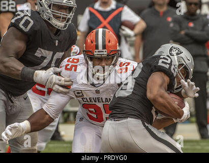 Oakland, California, USA. 30th Sep, 2018. Cleveland Browns defensive end Myles Garrett (95) tackles Oakland Raiders running back Doug Martin (28) on Sunday, September 30, 2018, at Oakland-Alameda County Coliseum in Oakland, California. The Raiders defeated the Browns 45-42 in an overtime game. Credit: Al Golub/ZUMA Wire/Alamy Live News Stock Photo