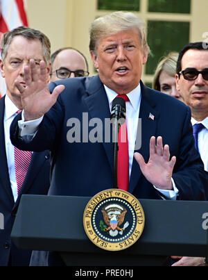 Washington, District of Columbia, USA. 1st Oct, 2018. United States President Donald J. Trump answers reporter's questions following his remarks on the United States Mexico Canada Agreement (USMCA) in the Rose Garden of the White House in Washington, DC on Monday, October 1, 2018. The President also took questions on the Kavanaugh nomination. Visible behind the President are US Trade Representative Robert Lighthizer, left, and US Secretary of the Treasury Steven T. Mnunchin, right Credit: Ron Sachs/CNP/ZUMA Wire/Alamy Live News Stock Photo