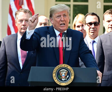 United States President Donald J. Trump answers reporter's questions following his remarks on the United States Mexico Canada Agreement (USMCA) in the Rose Garden of the White House in Washington, DC on Monday, October 1, 2018. The President also took questions on the Kavanaugh nomination. Visible behind the President are US Trade Representative Robert Lighthizer, left, and US Secretary of the Treasury Steven T. Mnunchin, right. Credit: Ron Sachs/CNP | usage worldwide Stock Photo