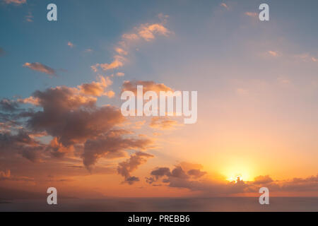 sunset sky above ocean background - scenic sky over water - colorful cloudy sky with evening sun Stock Photo