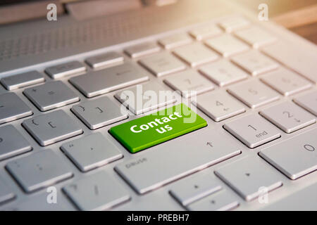 A 'contact us' message on enter key of keyboard, for online communications. Stock Photo