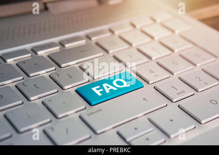 Keyboard with faq button . blue Color button on the gray silver keyboard of modern ultrabook. caption on the button Stock Photo