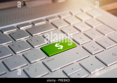 Closeup of computer keyboard with dollar button. Color button on the gray silver keyboard of modern ultrabook. caption on the button Stock Photo
