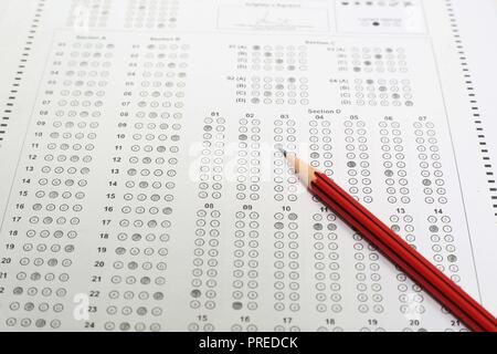 Pencil on OMR sheet. OMR sheet circles filled with pencil. Isolated on the white background. Stock Photo