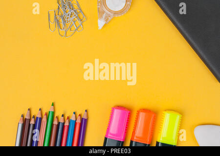 Stationery accessories lie on yellow background. Top view. Stock Photo