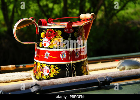 Brightly decorated hand painted canalware a traditional water can which was used by boatmen for carrying their fresh water on a barge Stock Photo