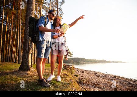 Happy couple going on a hike together in a forest.