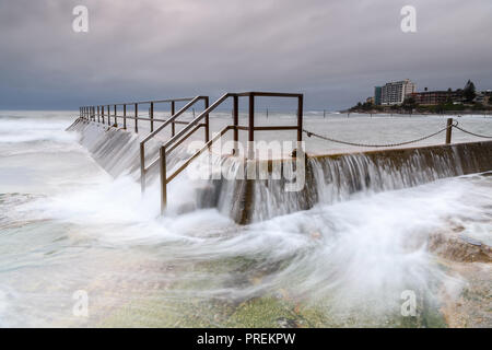 Flowing waves over an ocean swimming pool Stock Photo