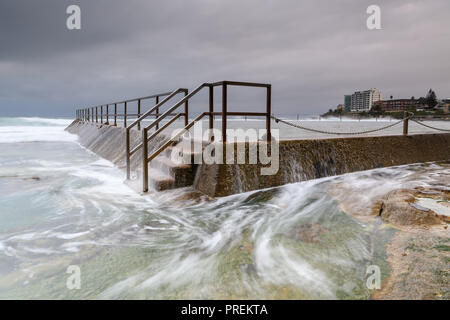 Flowing waves over an ocean swimming pool Stock Photo