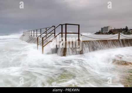 Flowing waves over an ocean swimming pool Stock Photo