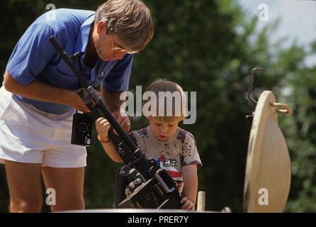 A little boy looks at a machine gun on a tank on the mall  at the Desert Storm Victory Parade in Washington on June 8,1991.  Photo by Dennis Brack BB 24 Stock Photo