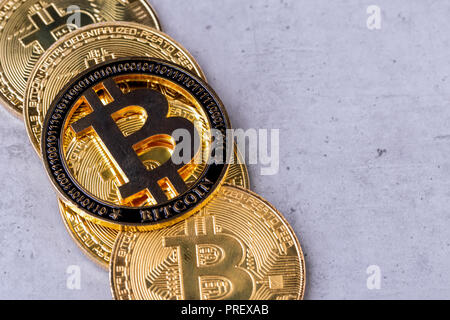 golden bitcoins on a concrete background, closeup photo Stock Photo