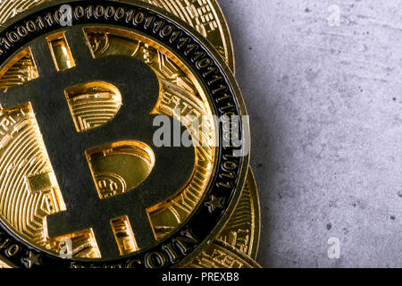 golden bitcoins on a concrete background, closeup photo Stock Photo