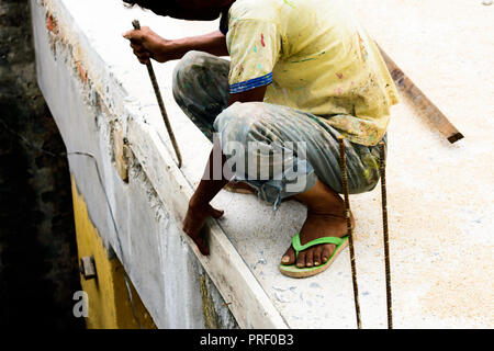 industrial worker, bricklayer, mason working on construction site with bricks and building house. masonry details Stock Photo
