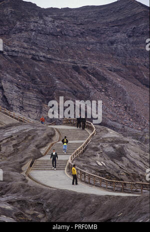 People walking around the top of the active volcano Mount Aso, Onsen, on the island of Kyushu in the southern part of Japan Stock Photo