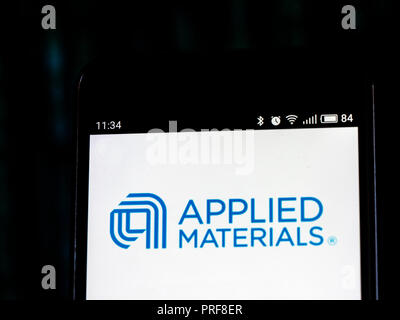 Applied Materials, Inc. logo seen displayed on smart phone. Applied Materials, Inc. is an American corporation that supplies equipment, services and software to enable the manufacture of semiconductor chips for electronics, flat panel displays for computers, smartphones and televisions, and solar products. Stock Photo