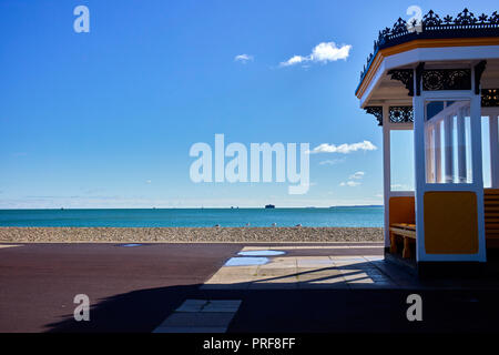 Victorian seating shelter on the seafront at Southsea, Portsmouth with beach and the Solent behind Stock Photo