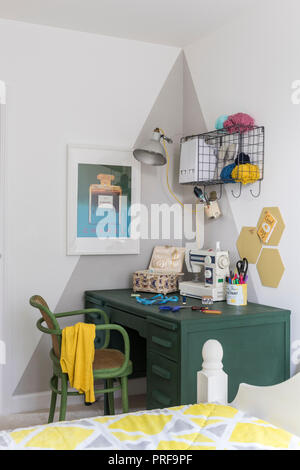 Painted desk and chair with sewing machine in London home Stock Photo