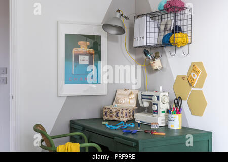 Painted desk and chair with sewing machine in London home Stock Photo
