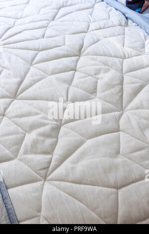 White geometric pattern on quilt Stock Photo